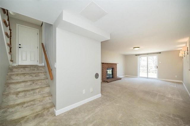 unfurnished living room featuring baseboards, carpet, a fireplace, and stairs