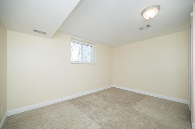 empty room with visible vents, baseboards, and carpet flooring