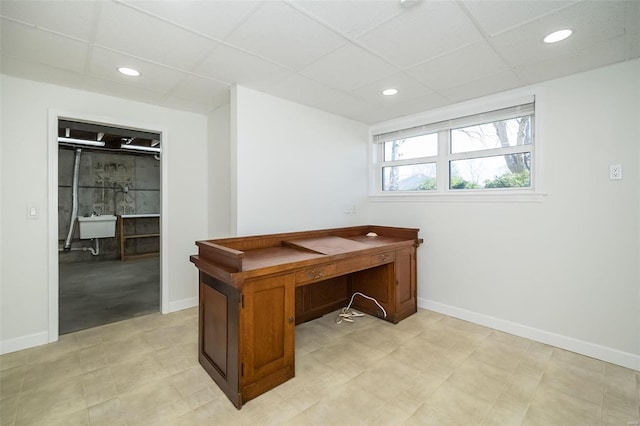 office area featuring recessed lighting, baseboards, and a drop ceiling