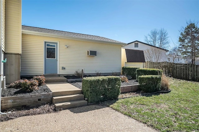 back of house featuring entry steps and fence