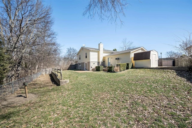 view of home's exterior featuring a fenced backyard, a lawn, and a chimney