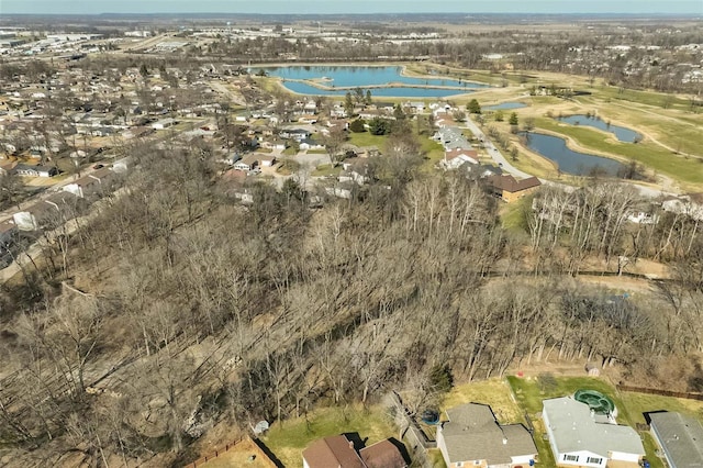 drone / aerial view with view of golf course and a water view