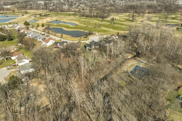 drone / aerial view with view of golf course and a water view