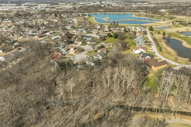 bird's eye view featuring golf course view, a water view, and a residential view