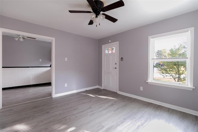 foyer featuring a ceiling fan, wood finished floors, and baseboards