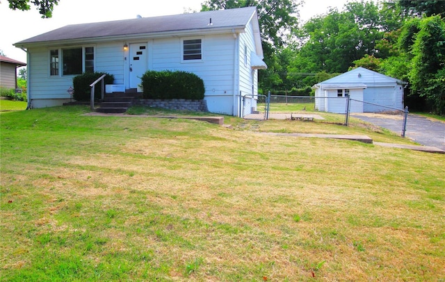 view of front of home with an outbuilding, fence, entry steps, a front lawn, and a garage