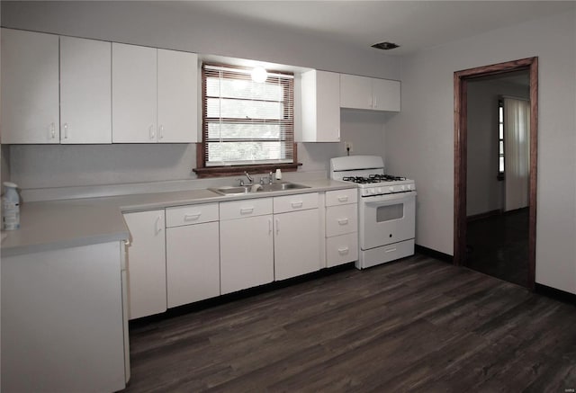 kitchen with white range with gas cooktop, dark wood-style flooring, a sink, light countertops, and white cabinetry