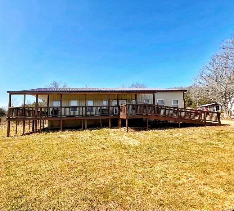 back of house featuring a wooden deck and metal roof