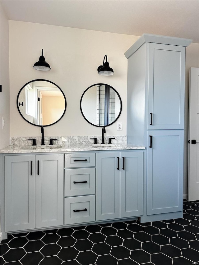 full bathroom with double vanity and a sink