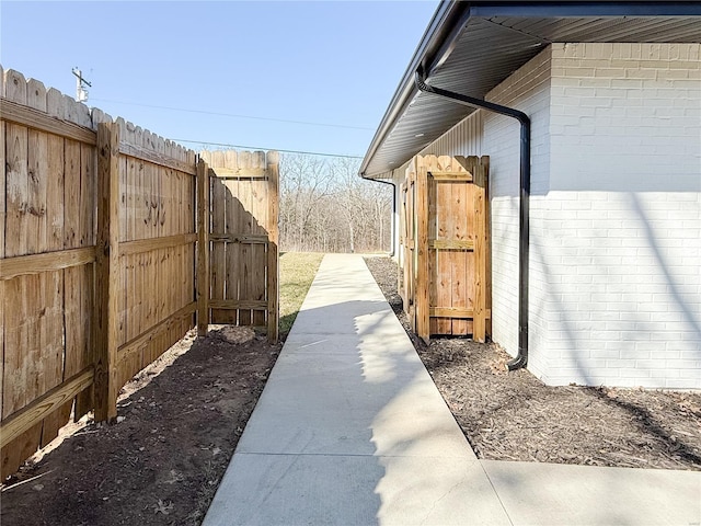 view of home's exterior featuring fence and brick siding