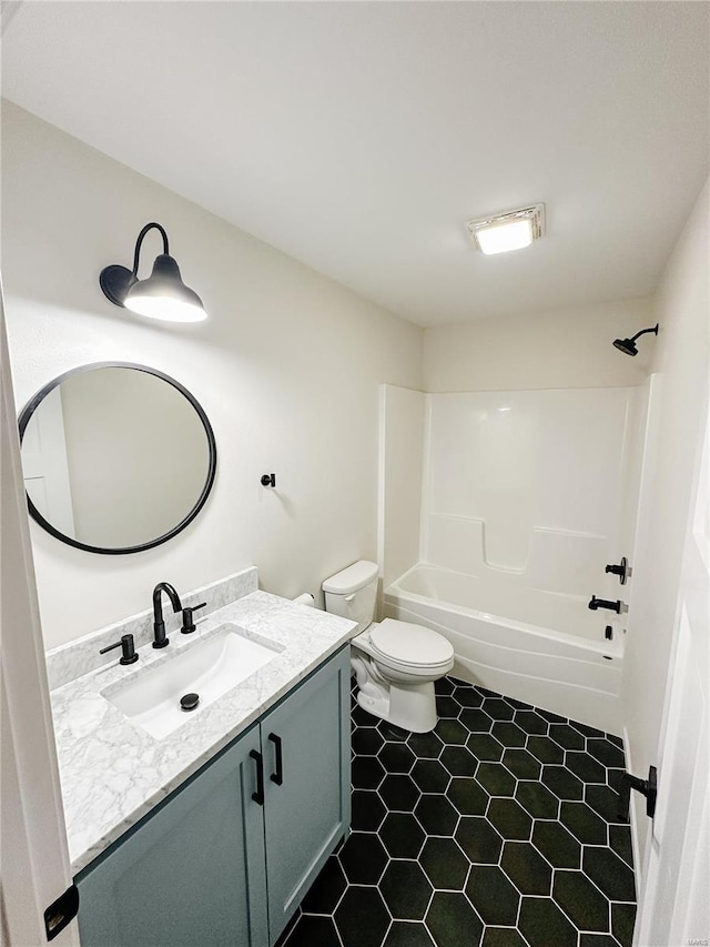 bathroom with toilet,  shower combination, and vanity