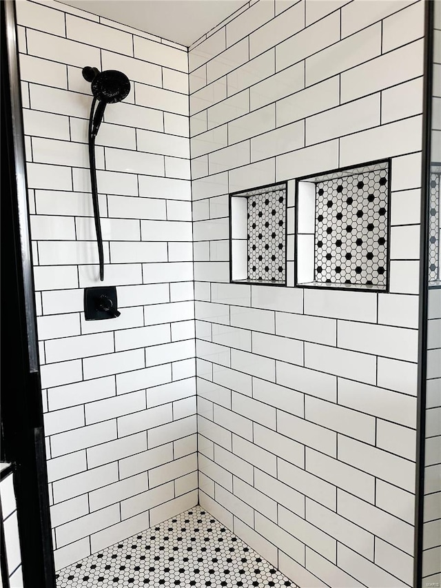 full bathroom with tiled shower