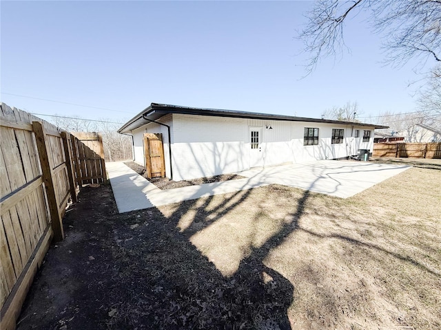 back of property with a patio area, a fenced backyard, and brick siding