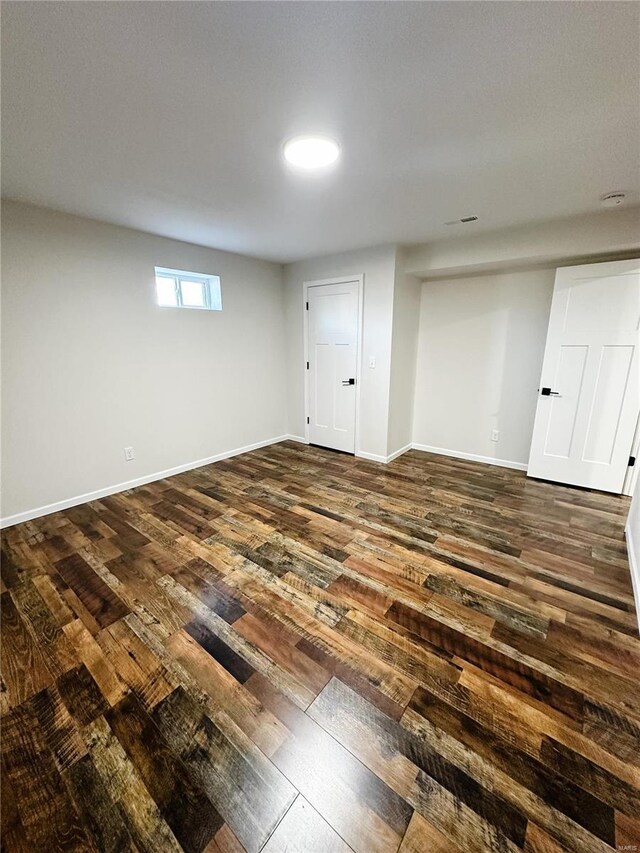 basement featuring dark wood-style floors and baseboards