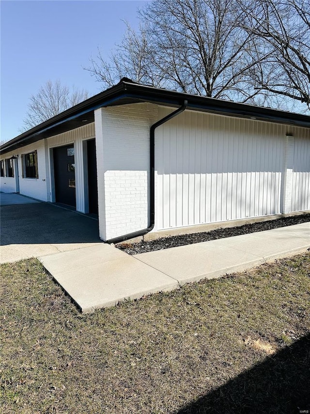 view of side of property featuring brick siding