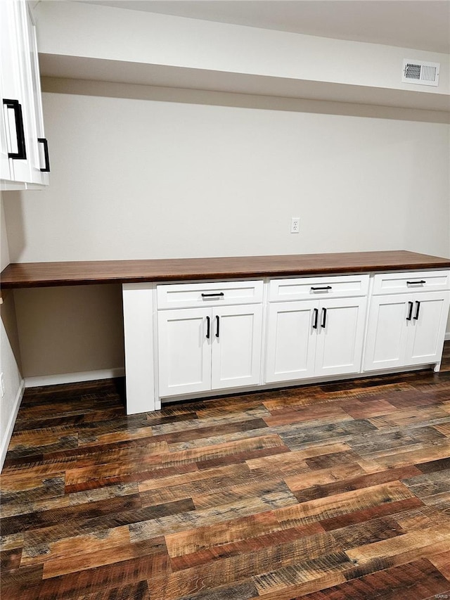 interior space featuring visible vents, baseboards, and wood finished floors