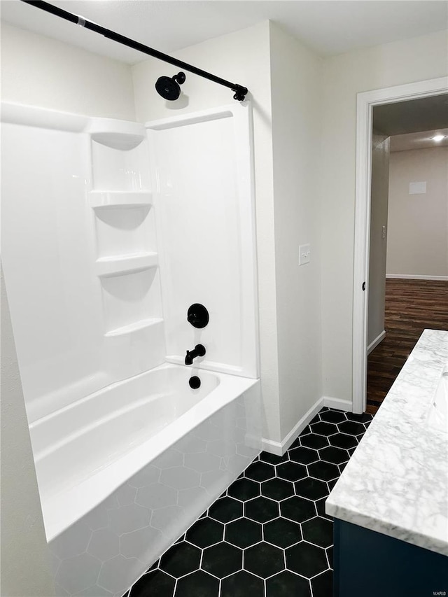 full bath with vanity, bathtub / shower combination, and baseboards