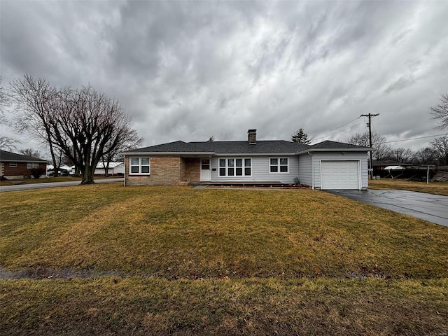 ranch-style home featuring driveway, a front lawn, a chimney, and an attached garage