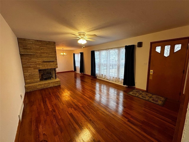 unfurnished living room with hardwood / wood-style floors, a fireplace, baseboards, and a textured ceiling