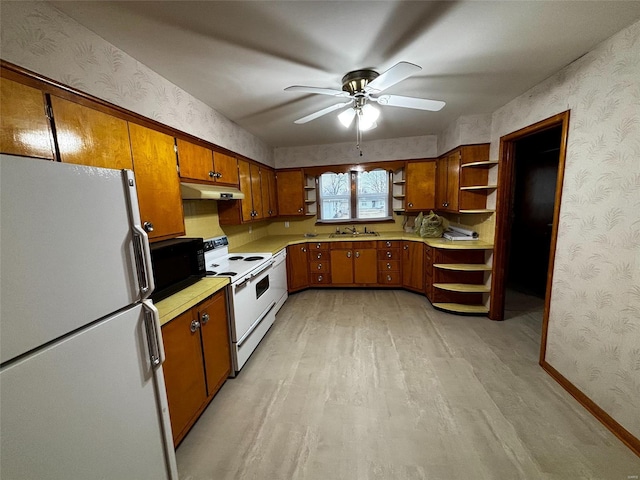 kitchen with wallpapered walls, white appliances, open shelves, and under cabinet range hood