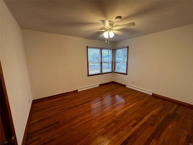 unfurnished room with baseboards, ceiling fan, dark wood-type flooring, a baseboard heating unit, and baseboard heating