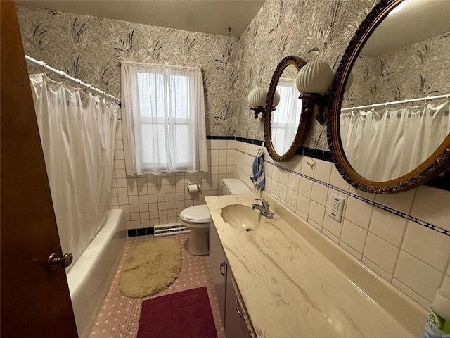 bathroom with visible vents, wallpapered walls, toilet, vanity, and tile walls