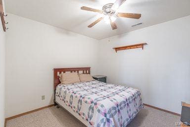 bedroom featuring visible vents, carpet, baseboards, and ceiling fan