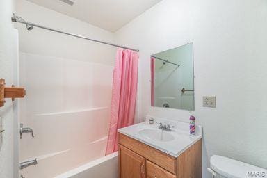 bathroom featuring toilet, vanity, and shower / bath combination with curtain