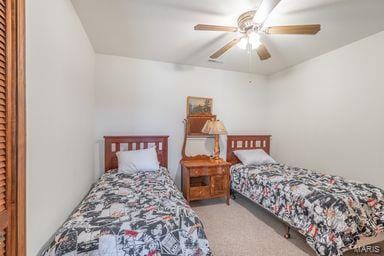 bedroom featuring a ceiling fan and carpet