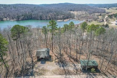 aerial view with a forest view and a water view