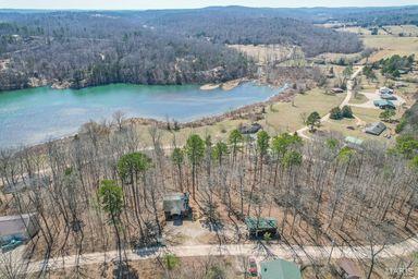 aerial view with a forest view and a water view