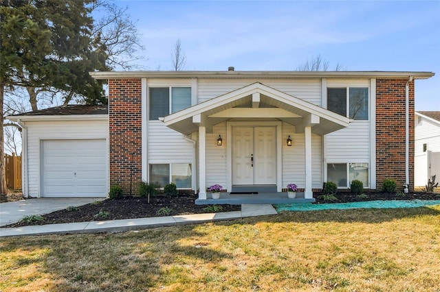 traditional home featuring a front yard, concrete driveway, brick siding, and a garage