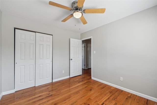 unfurnished bedroom featuring light wood finished floors, ceiling fan, a closet, and baseboards