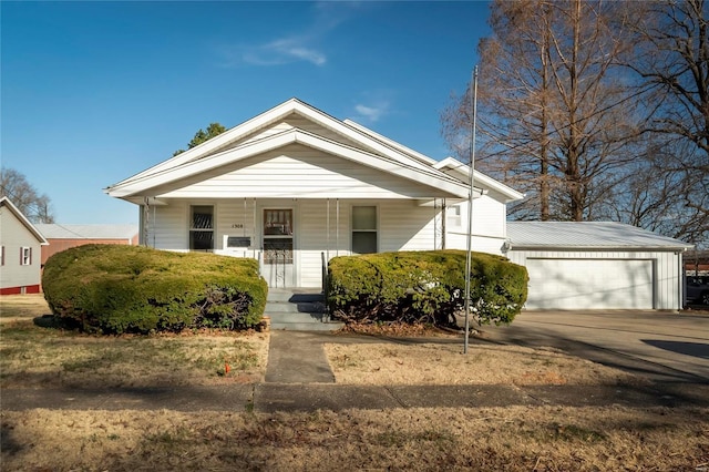 bungalow-style house featuring a garage and covered porch