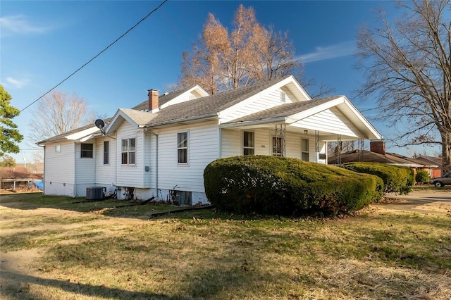 view of property exterior with a lawn, cooling unit, a chimney, and a shingled roof