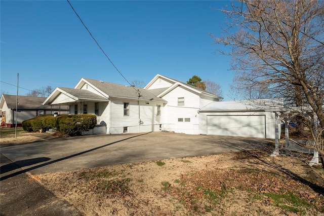 view of property exterior featuring driveway and an attached garage