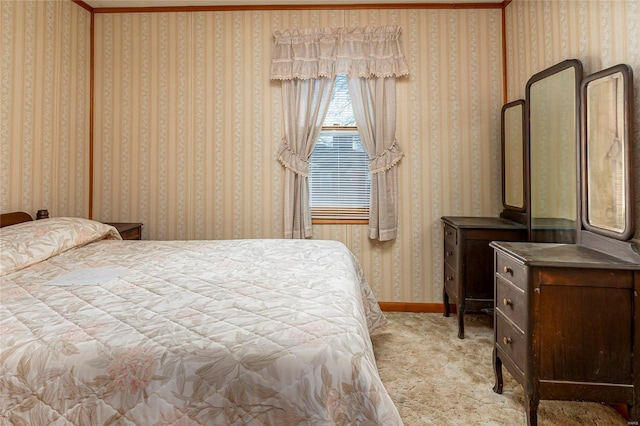 carpeted bedroom featuring baseboards and wallpapered walls