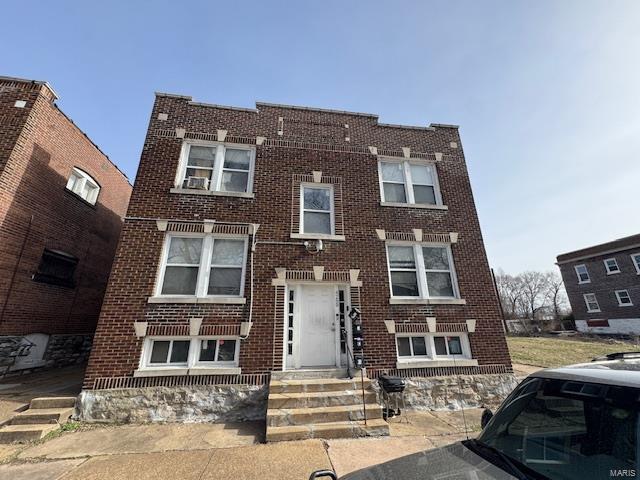 view of front of property with brick siding and entry steps