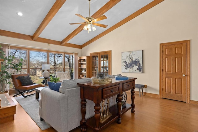 living room with beamed ceiling, high vaulted ceiling, wood finished floors, baseboards, and ceiling fan