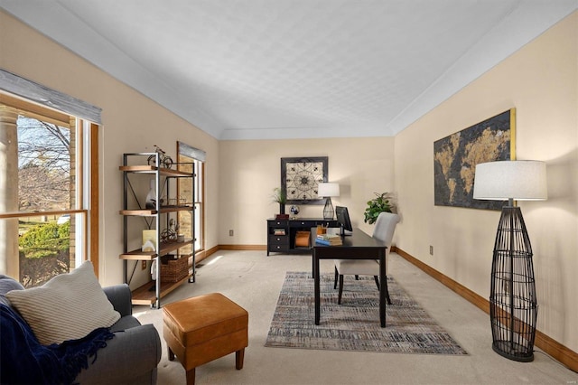 home office with light colored carpet and baseboards