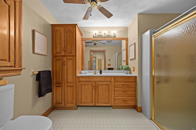 full bath with tile patterned floors, toilet, a ceiling fan, and a stall shower