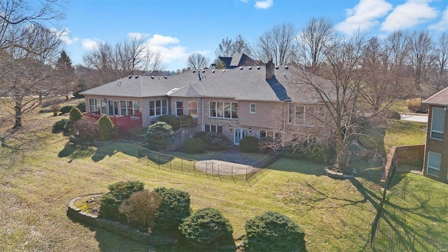 rear view of property featuring a yard