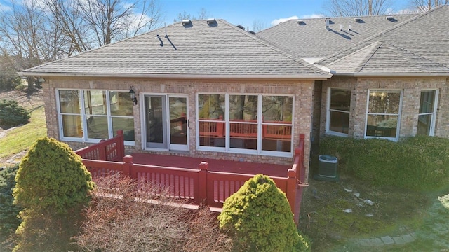 exterior space featuring cooling unit and roof with shingles