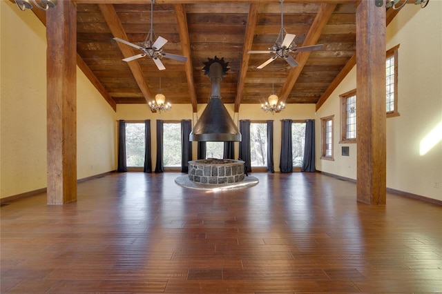 unfurnished living room featuring wooden ceiling, a wood stove, and ceiling fan with notable chandelier