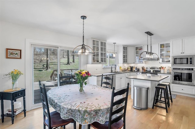 dining space featuring light wood-style floors