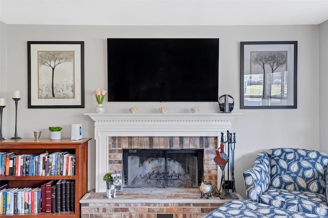 living area with a brick fireplace