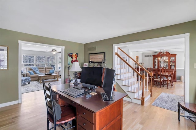 office with visible vents, a ceiling fan, light wood-type flooring, and baseboards