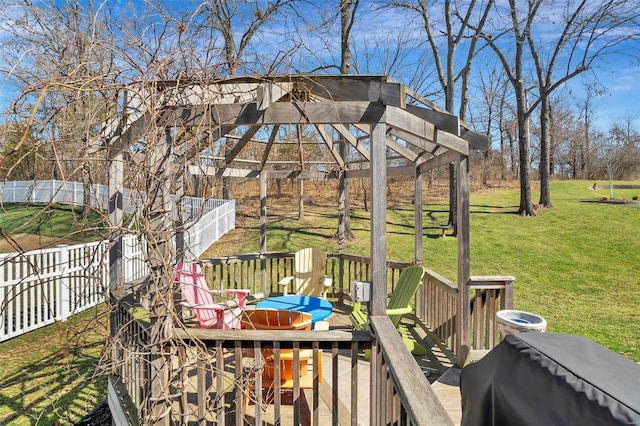 deck with grilling area, a lawn, and fence