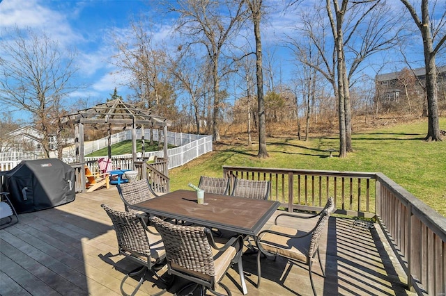 wooden deck with a fenced backyard, outdoor dining space, a yard, and area for grilling