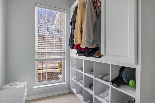 mudroom with light tile patterned floors and baseboards